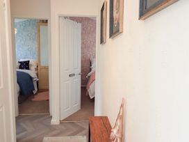 A hallway with doors leading to bedrooms at Charnwood