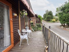 An outdoor seating area with a table and chairs at Charnwood