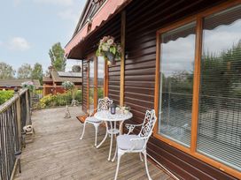 A deck with a table and chairs at Charnwood