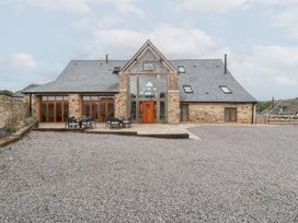 An outdoor area with a house and patio furniture at Two Parks Barn Upton Bishop near Ross-On-Wye