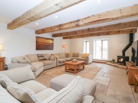 A living room with a coffee table and a fireplace at Two Parks Barn near Ross-On-Wye