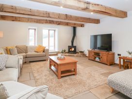 A living room with a coffee table and television at Two Parks Barn Upton Bishop near Ross-On-Wye