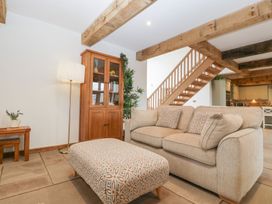 A living room with a sofa and ottoman at Two Parks Barn Upton Bishop near Ross-On-Wye