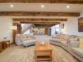 A living room with sofas and a table at Two Parks Barn Upton Bishop near Ross-On-Wye