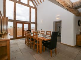 A dining room with a large table and chairs at Two Parks Barn Upton Bishop near Ross-On-Wye