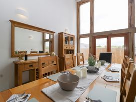 A dining room with a table and chairs at Two Parks Barn Upton Bishop near Ross-On-Wye