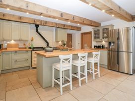 A kitchen with a refrigerator and stove at Two Parks Barn Upton Bishop near Ross-On-Wye