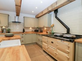 A kitchen with cabinets and a stove at Two Parks Barn in Upton Bishop near Ross-On-Wye