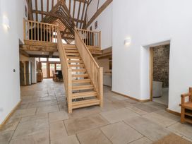 An entrance hall with a staircase and kitchen table at Two Parks Barn Upton Bishop near Ross-On-Wye