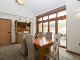 A dining room with a table and chairs at Two Parks Barn in Upton Bishop near Ross-On-Wye