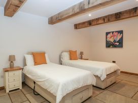 A bedroom with two beds and a painting at Two Parks Barn Upton Bishop near Ross-On-Wye
