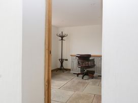 An office with a chair and coat rack at Two Parks Barn Upton Bishop near Ross-On-Wye