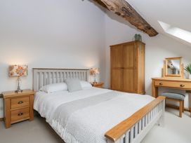 A bedroom with a bed and furniture at Two Parks Barn Upton Bishop near Ross-On-Wye
