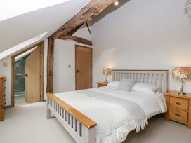 A bedroom with a bed and nightstands at Two Parks Barn Upton Bishop near Ross-On-Wye