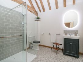 A bathroom with a shower, toilet, and wash basin at Two Parks Barn near Upton Bishop