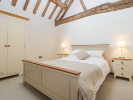 A bedroom with a bed and side tables at Two Parks Barn Upton Bishop near Ross-On-Wye