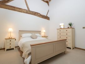 A bedroom with a bed and nightstands at Two Parks Barn Upton Bishop near Ross-On-Wye