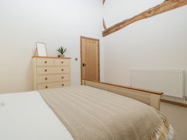 A bedroom with a bed and a dresser at Two Parks Barn Upton Bishop near Ross-On-Wye