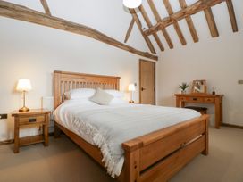 A bedroom with a bed and furniture at Two Parks Barn near Ross-On-Wye