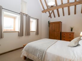 A bedroom with a bed and a wardrobe at Two Parks Barn Upton Bishop near Ross-On-Wye