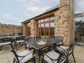 An outdoor patio with a table and chairs at Two Parks Barn Upton Bishop near Ross-On-Wye