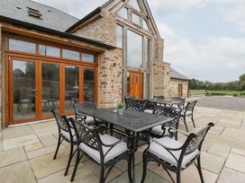 An outdoor dining area with a table and chairs at Two Parks Barn Upton Bishop near Ross-On-Wye