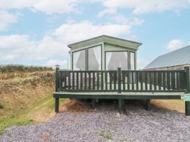 A cabin with a deck area at Bryncrin in Edern