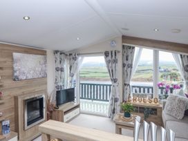 A living room with a television and a view at Bryncrin in Edern