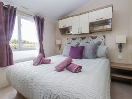 A bedroom with a bed and pillows at Bryncrin in Edern