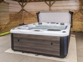 A hot tub with a cover at Bryncrin Edern near Morfa Nefyn