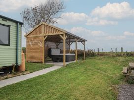An outdoor area with a shelter and hot tub at Bryncrin Edern near Morfa Nefyn