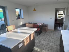 A kitchen with a dining table and chairs at Knocknanuss