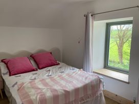 A bedroom with a bed and window at Knocknanuss