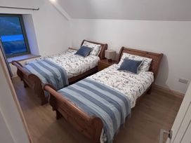 A bedroom with two twin beds and bedside tables at Knocknanuss