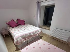 A bedroom with a bed and nightstand at Knocknanuss