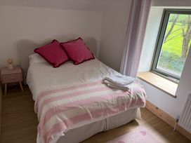 A bedroom with bed and nightstand at Knocknanuss Ballinascarty County Cork