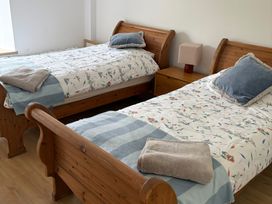 A bedroom with two single beds and a nightstand at Knocknanuss Ballinascarty, County Cork