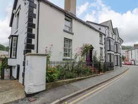 A house with flowers in the garden on a street at Bryn Dwr in Llangollen