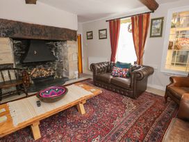 A living room with a fireplace and sofa at Bryn Dwr in Llangollen