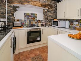 A kitchen with various appliances and a bowl of croissants at Bryn Dwr in Llangollen