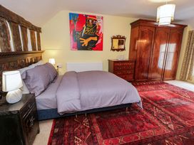 A bedroom with a bed and wardrobe at Bryn Dwr in Llangollen