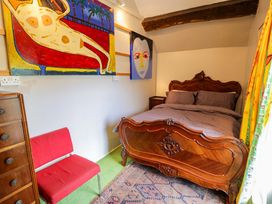 A bedroom featuring a bed and artwork at Bryn Dwr Llangollen