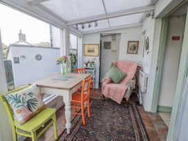 A conservatory with a table and chairs at Bryn Dwr in Llangollen