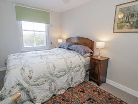 A bedroom with a bed and nightstand at Bryn Dwr in Llangollen