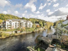 A view of an apartment building by a river at Bryn Dwr in Llangollen