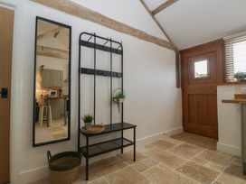 An entrance with a coat rack and mirror at The Old Cart Shed in Gorsley