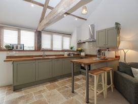 A kitchen with cabinets and appliances at The Old Cart Shed in Gorsley