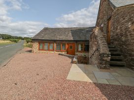 An outdoor view of a house with gravel path at The Old Cart Shed in Gorsley