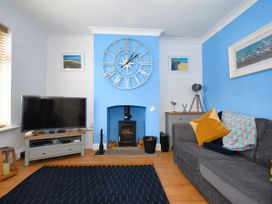 A living room with a television and a fireplace at Seahorse in Filey