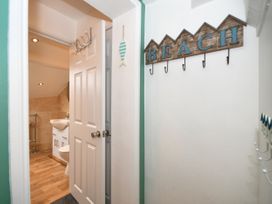 A bathroom with a sink and door at Seahorse in Filey